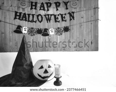 Halloween letters on dark background  Next to it are pictures of ghosts and pumpkins, candles, and spiders, representing the Halloween festival.
