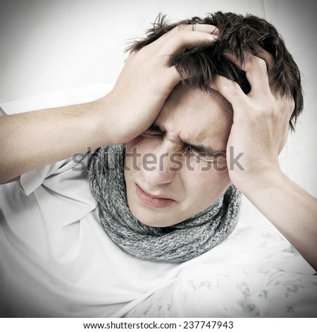 Vignetting Photo of Sick Young Man with Headache on the Bed
