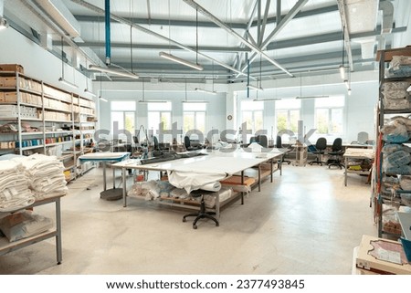Interior of a sewing warehouse of furniture factory with equipment and materials Royalty-Free Stock Photo #2377493845