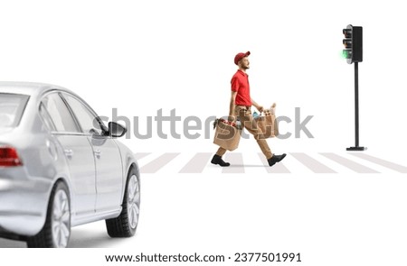 Car waiting at pedestrian and delivery guy carrying bags with groceries and crossing a street isolated on white background