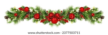 Snowberries with green twigs of Christmas tree, red decorations and cones in a holiday waved garland isolated on white Royalty-Free Stock Photo #2377503711