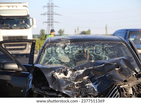 The mangled front part of a car after a head-on crash accident with a truck
 Royalty-Free Stock Photo #2377511369