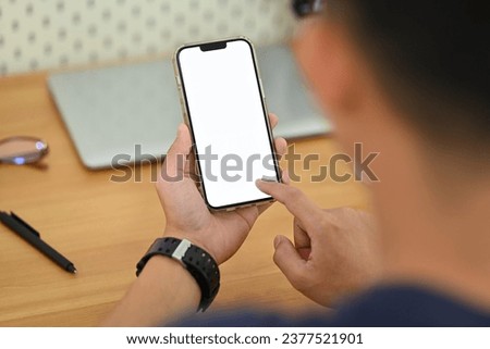 Man hands using smartphone at workplace. Blank screen for your advertising text message.