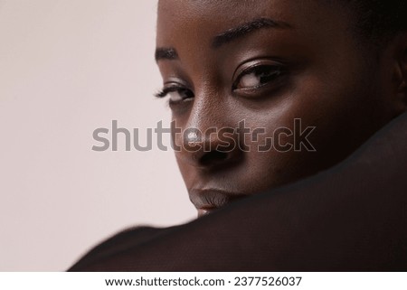 Young woman confidently looks at camera has expression reveals depth of thought  Royalty-Free Stock Photo #2377526037