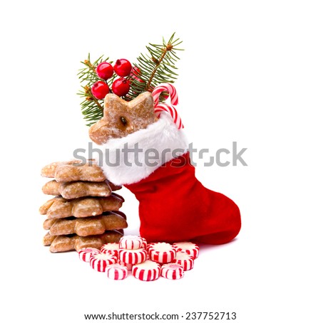 Christmas stocking, candy and cookies on white background