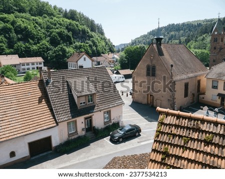 An aerial perspective captures Abbaye de Graufthal, framed by Rue Principale in Eschbourg, Alsace, with a solitary parked car