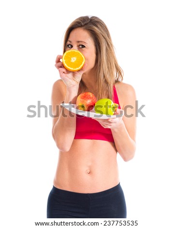 Sport woman holding fruits