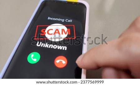 Scam Alert. A mobile phone showing incoming call from unknown Royalty-Free Stock Photo #2377569999