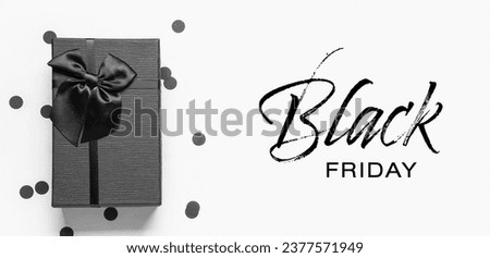Gift box and text BLACK FRIDAY on white background Royalty-Free Stock Photo #2377571949