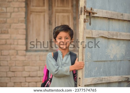 Portrait of 5 Year old boy student from Punjab Pakistan. Pakistani baby boy wearing school bag and ready to go to school. Education concept.Education in village of pakistan. Asian people from Pakistan Royalty-Free Stock Photo #2377574765