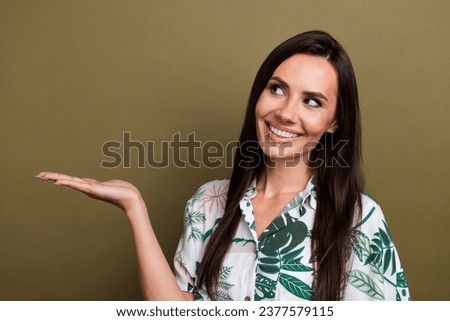 Portrait of adorable lovely cute woman wear stylish shirt arm presenting object look empty space isolated on brown color background