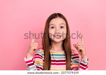 Portrait of small young schoolgirl direct fingers above head like optimistic prepare knowledge day isolated on pink color background
