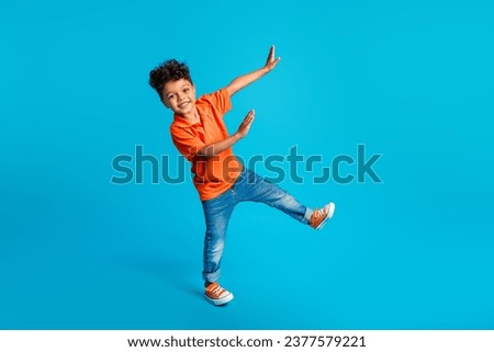 Full body size photo of dance cool little boy showing his arms dab carefree weekend positive mood disco isolated on blue color background Royalty-Free Stock Photo #2377579221