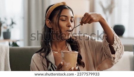 Woman, eating ice cream and living room on sofa, thinking or idea for dessert, sweets or relax in home. Girl, gelato or frozen yogurt for snack, lounge couch and house with memory, choice or decision Royalty-Free Stock Photo #2377579933