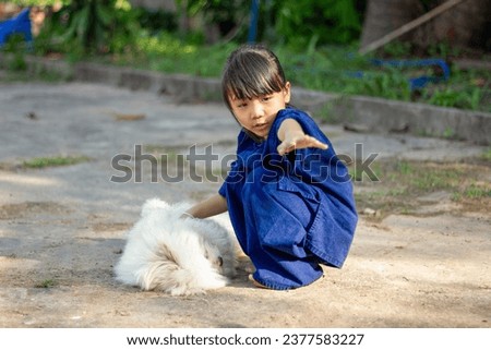 little girl plays happily with a dog