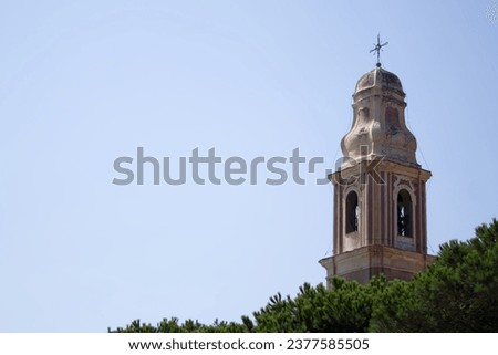 An ancient bell tower against a background of blue sky copy space