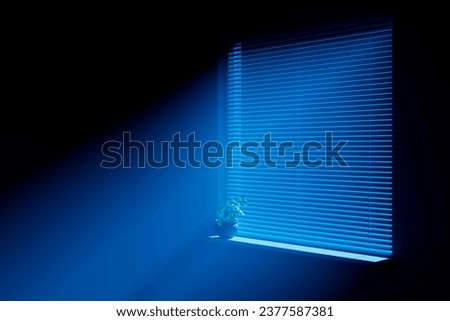 Moonlight on the floor through a window with horizontal blinds. Royalty-Free Stock Photo #2377587381