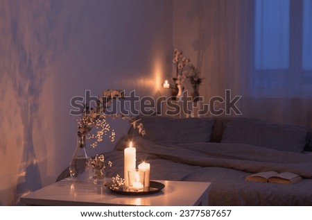 night interior of bedroom with flowers and burning candles Royalty-Free Stock Photo #2377587657