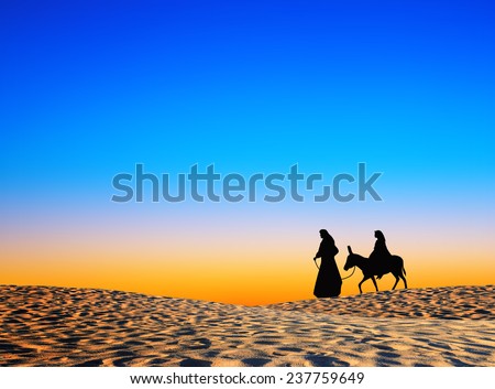 Nativity Christmas concept: Silhouette pregnant Mary and Joseph journeying through the dessert with donkey go to Bethlehem