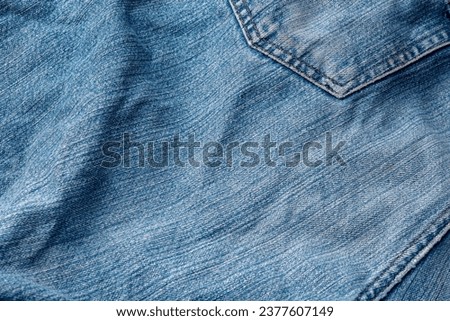 Jeans Fabric Pattern Background: Jeans Background Image Creating a background picture with a fabric pattern for jeans can add a unique and stylish touch to your design. Here's how you can describe Royalty-Free Stock Photo #2377607149