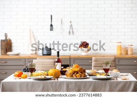 Festive table setting with tasty food for Thanksgiving Day in kitchen Royalty-Free Stock Photo #2377614883