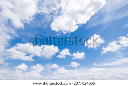 Panoramic view of clear blue sky and clouds, Blue sky background with tiny clouds. White fluffy clouds in the blue sky. Captivating stock photo featuring the mesmerizing beauty of the sky and clouds.
