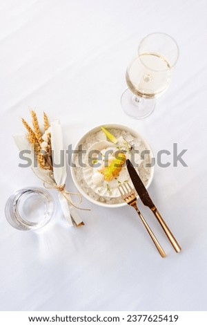 Scallop in sauce with flying fish caviar on a shell on ice in a restaurant. High quality photo Royalty-Free Stock Photo #2377625419