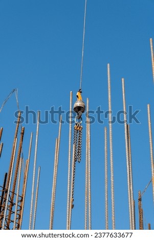 Construction crane arm with Jib crane boom against blue sky background