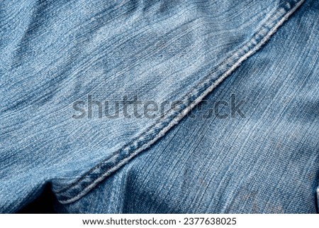 Jeans Fabric Pattern Background: Jeans Background Image Creating a background picture with a fabric pattern for jeans can add a unique and stylish touch to your design. Here's how you can describe Royalty-Free Stock Photo #2377638025
