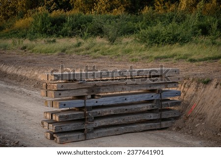 Wooden barricade on dirt road