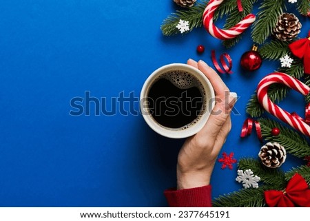 Woman holding cup of coffee. Woman hands holding a mug with hot coffee. Winter and Christmas time concept.
