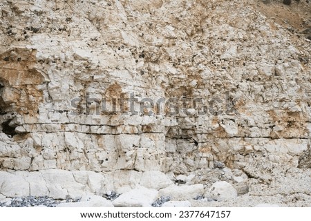 White cliffs background at Cuckmere Haven beach in Hope Gap. Located between Eastbourne and Seaford in East Sussex, UK Royalty-Free Stock Photo #2377647157
