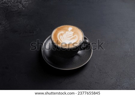 Cup of cappuccino on a dark background. Selective focus. Royalty-Free Stock Photo #2377655845