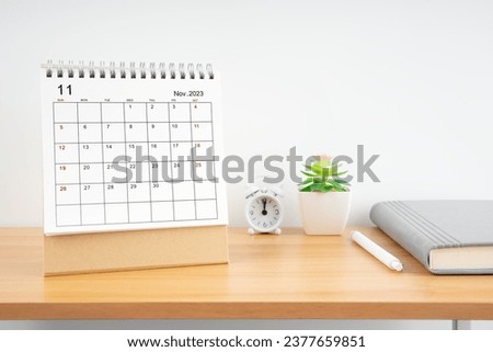 November 2023, Monthly desk calendar for 2023 year on wooden table with diary. Royalty-Free Stock Photo #2377659851