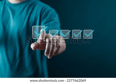 Businessman showing check mark summarizing work details, checklist, documents and online quality assessment standards. Royalty-Free Stock Photo #2377662069