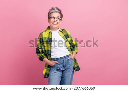 Photo of optimistic woman with short hairstyle wear checkered shirt indicaitng at sale empty space isolated on pink color background