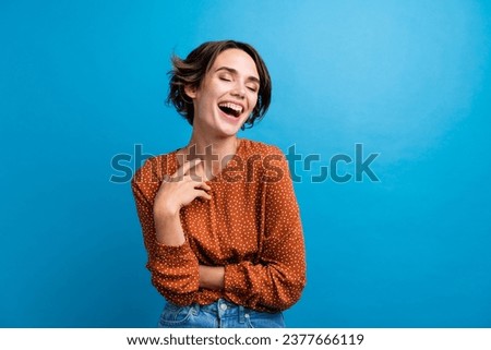Photo of young cheery girl gesturing her hand laughing out loud wear casual outfit isolated over blue color background