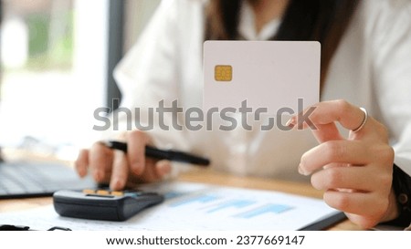 Woman's Hands using credit card for shopping online.