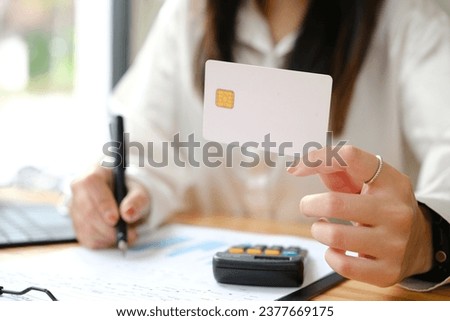 Woman's Hands using credit card for shopping online.