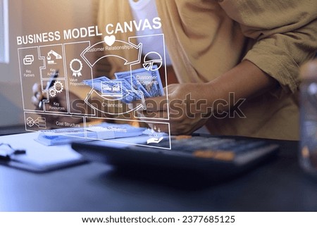 Business model canvas concept. Entrepreneur holding banknote and planning to investment in business on desktop
