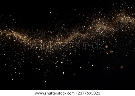 Gold dust glitter sparkle wave texture on the black background. Shimmer texture.