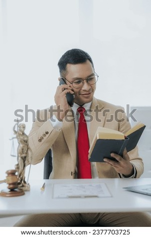 Male lawyer working in office with contract and legal documents when sitting at table. Law, legal service, advice, justice and real estate concept.