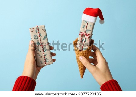 Ice cream cone with a gift and Santa's hat