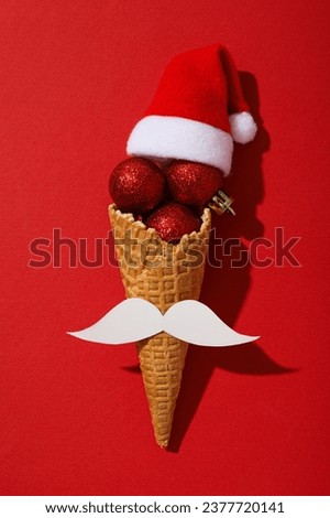 An ice cream cone with a mustache and a Santa hat