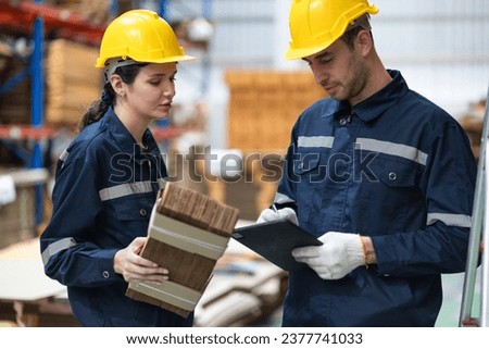 Caucasian businesswoman with buddy using clipboard checking wood Kraft stock in warehouse	