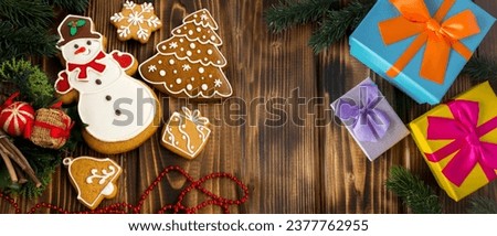 Christmas gingerbread and gift box on the wooden background. Top view. Copy space.
