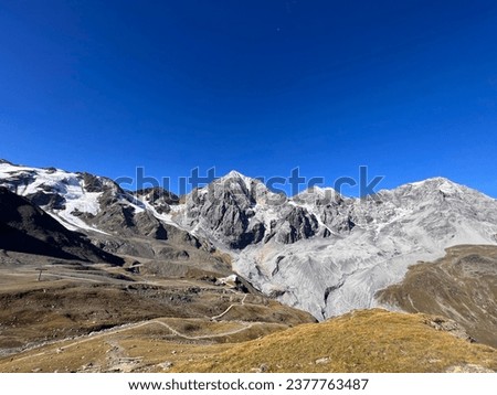 a beautiful mountain range with snow-capped peaks. a beautiful view with blue sky. Royalty-Free Stock Photo #2377763487