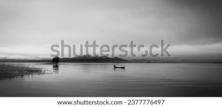 Fisherman in boat on lake with Black and White Pictures