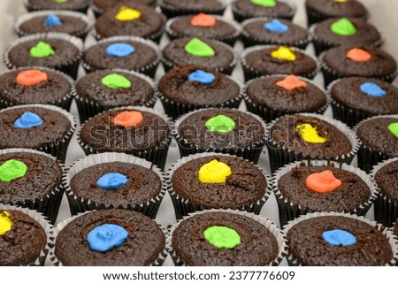 multi color muffins produce at professional catering baker in professional kitchen