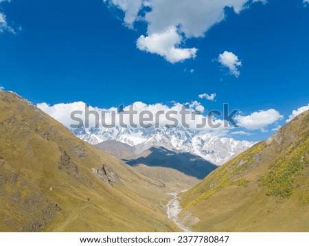 Aerial panoramic view of traditional Svaneti village Ushguli located at the head of the Enguri gorge and Shkhara Peak in the Greater Caucasus Mountain Range,the highest point in the country of Georgia